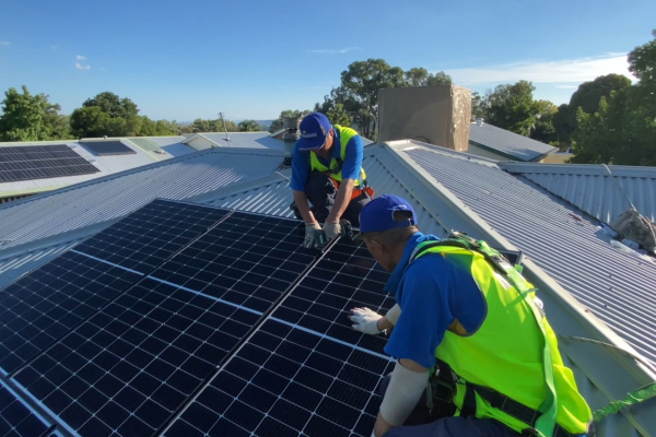 Two solar installers installing roof top solar
