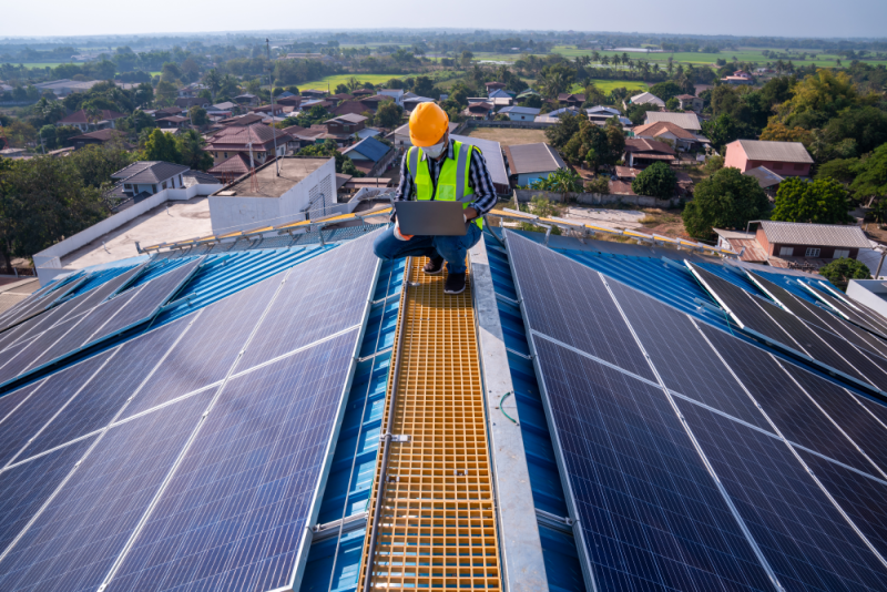 A solar installer checking Solar panel on the rooftop